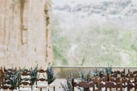 04 a castle terrace used as a ceremony space, chairs decorated with blooms, and a grorgeous backdrop
