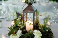 04 a metal candle lantern on a moss piece, with herbs and white blooms looks amazing for a woodland wedidng tablescape