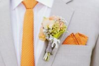 05 a light grey suit with a white shirt and a polka dot orange tie and a handkerchief