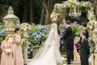 05 refined castle garden turned into a ceremony space, gorgeous blooms and urns with florals