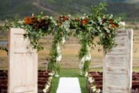 05 use rustic doors, leaves and greenery for the welcome doors and there can be nothing better than a naturally beautiful backdrop