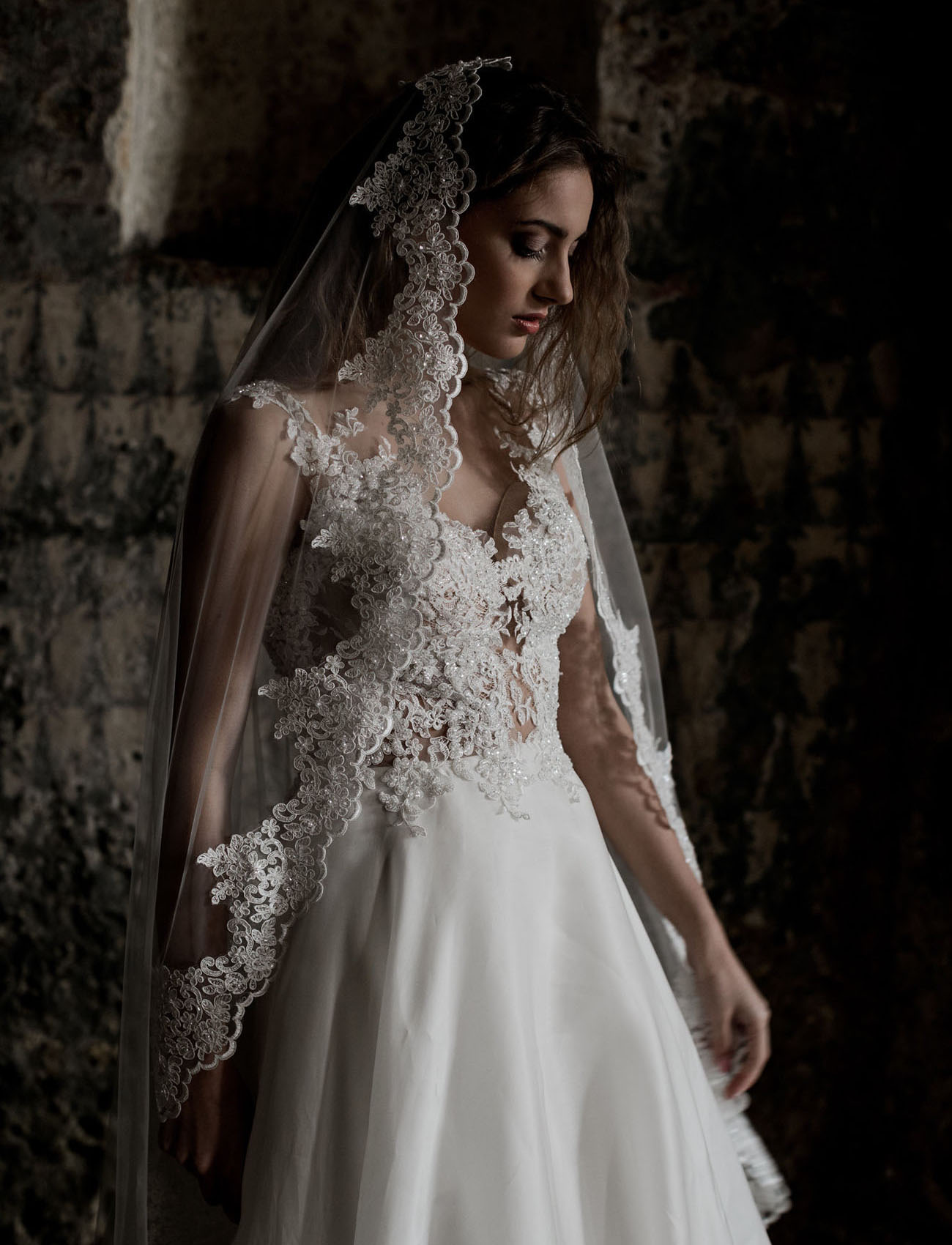 The bride was wearing a gorgeous lace bodice V neck wedding dress with a silk skirt and a mantilla veil with lace