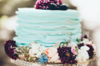 06 The wedding cake was an aqua-colored one, with bold blooms and topped with fresh berries
