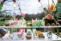 07 Drinks and desserts served on a glass stand and a moss stand with macaron pops become a part of decor