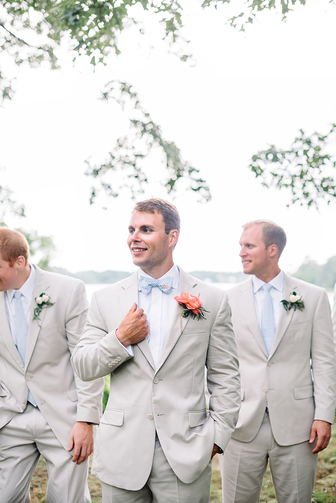 The groom and groomsmen were wearing neutral suits, white shirts and blue ties