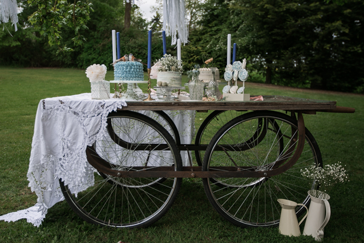The wedding dessert table was a vintage trolley, and it was decorated with a lace tablecloth and candles