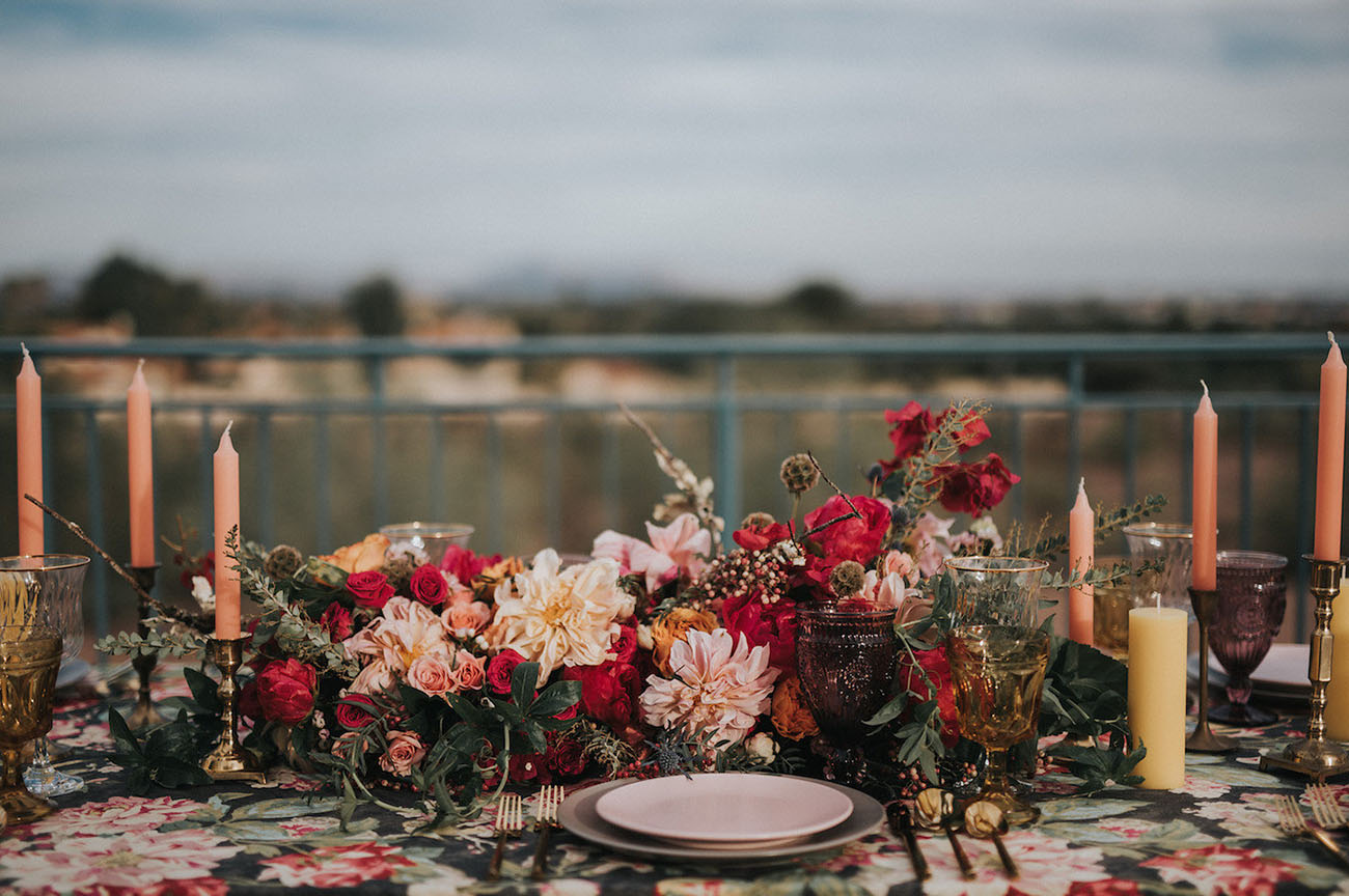 The centerpiece is stunning, moody with soft blush and hot red blooms
