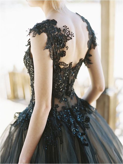 a refined wedding dress with a black lace bodice with rhinestones and a tulle skirt