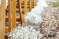 08 wooden chairs and buckets with baby’s breath for a ranch wedding aisle