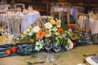 09 The wedding tablescape featured a grey velvet table runner, apples and a bold orange centerpiece that reminded of Dutch Masters’ still lifes