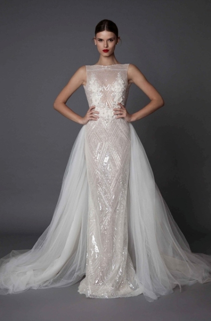 a spakling sleeveless sheath wedding dress with lace appliques and an additional tulle overskirt
