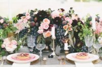 10 a lush summer centerpiece with blush, plum and burgundy flowers, blackberries, figs and grapes for a summer or fall wedding