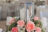 10 a shiny candle lantern with a coral rose and succulents arrangement and candles around looks trendy