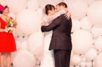10 white balloons of different sizes that comprise a wedding backdrop