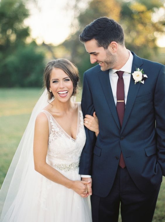 a navy two piece wedding suit with a white shirt and a plum tie