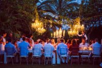 12 Candles and glam chandeliers lit up the reception at night