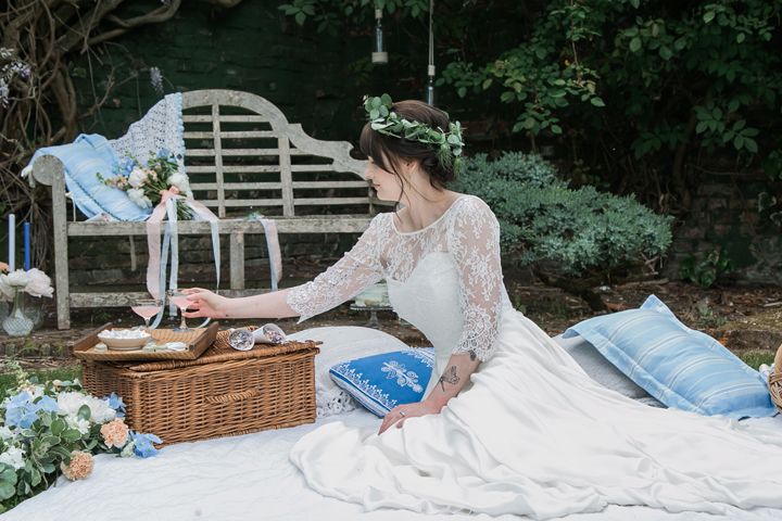 The picnic setting with baskets, flowers and blue pillows for those who want a laid-back wedding