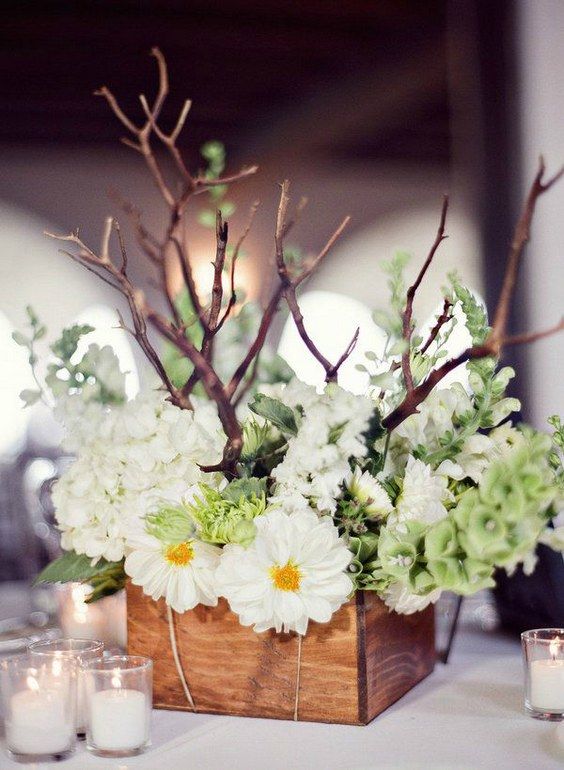 a wooden box with white blooms and branches for a rustic wedding