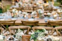 13 candle lanterns, wood table numbers, simple wildflowers for a rustic wedding reception
