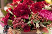 14 a bold summer arrangement with ruby red blooms and raspberries for a summer celebration