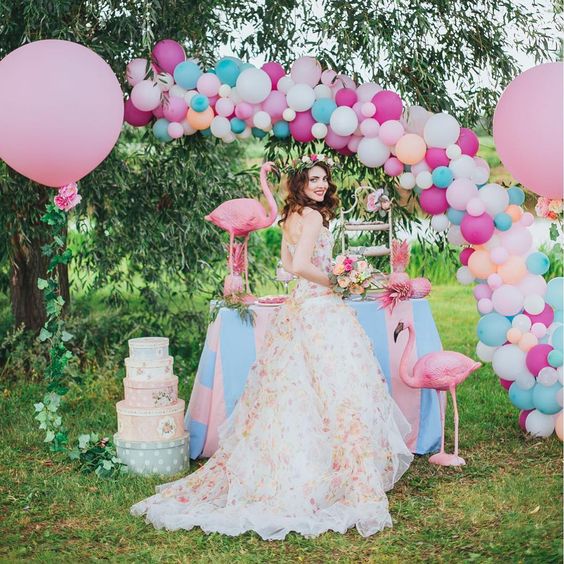 a colorful balloon arch over the dessert table for bold decor