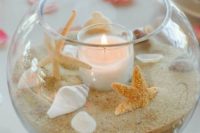 14 a glass bowl with beach sand, shells, starfish and a blush candle is a perfect fit for a beach wedding