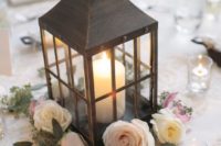 14 an elegant dark lantern with a candle and surrounded with roses for a chic look