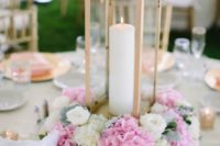 15 a buttermilk-colored metal lantern with pink and neutral blooms and a framed table number for a cozy backyard wedding