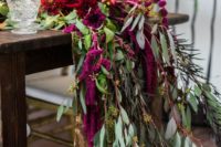 15 lush fuchsia and red blooms and lots of greenery for a stunning table runner