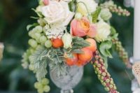 16 a crystal vase with white and peachy roses, green grapes and fruits for a relaxed summer wedding