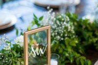 16 framed copper table number and a lush greenery table runner