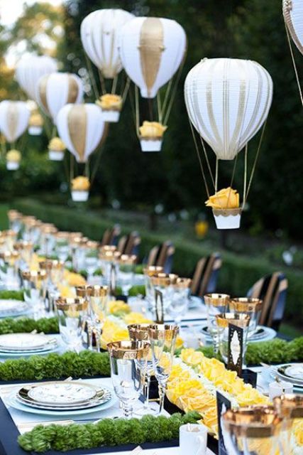 balloons in hot air balloons hanging over the reception create a dreamy ambience