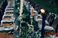 17 dark greenery table runner with candles in vintage candleholders for a moody or Halloween wedding