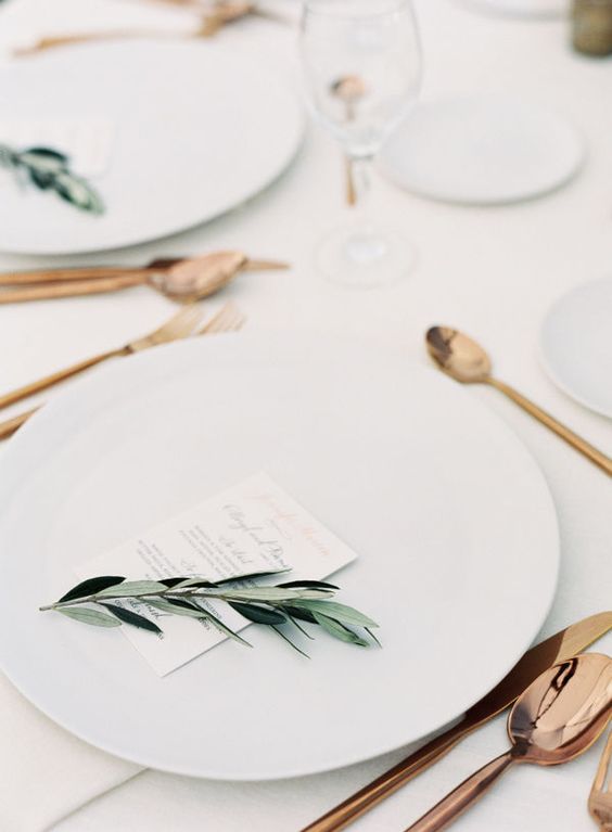 spruce up a neutral table setting with emerald greenery and copper cutlery