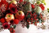 18 a bold fall or winter centerpiece with apples, berries, artichokes and textural blooms and leaves