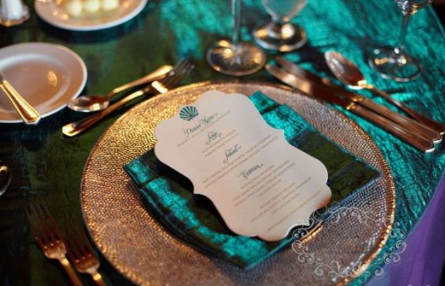 copper flatware and chargers, shiny teal npakins and a tablecloth for an exquisite look