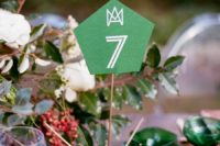 18 glitter copper ball with sticks and an emerald table number, greenery and emerald glasses