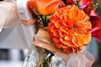 18 orange flower arrangement in a mason jar for wedding aisle decor