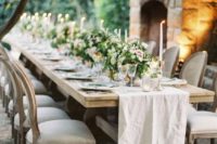 18 very elegant ranch wedding reception with a fireplace, lush greenery and pink flower centerpieces