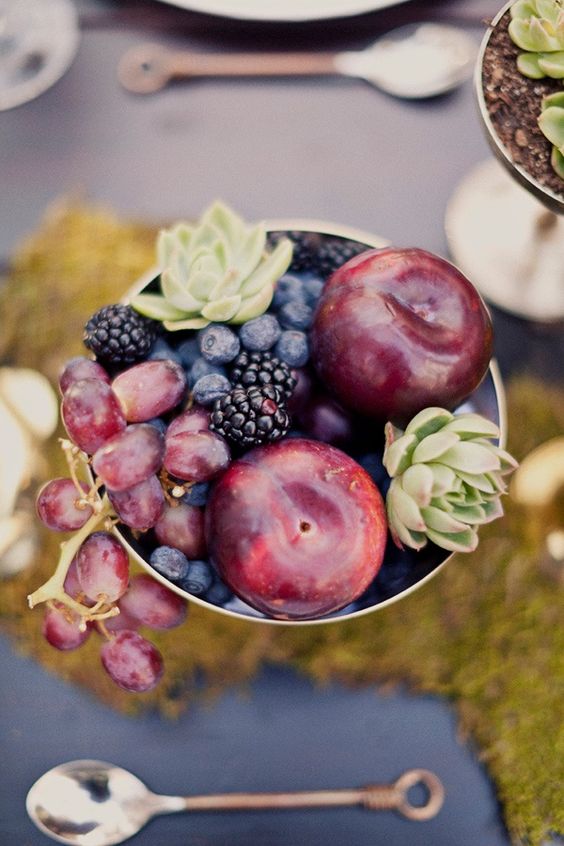 a chic centerpiece with grapes, plums, blackberries, blueberries and succulents
