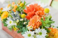 19 a rustic wedding centerpiece in a box with white, orange and yellow flowers