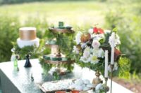 19 copper mugs, copper cupcake stands and lots of greenery for a dessert table