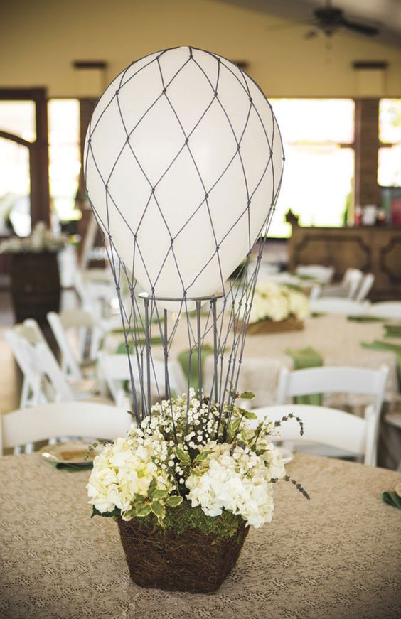 hot air balloon centerpiece with neutral florals and a white balloon