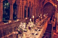 20 one of the castle galleries is turned into a beautiful reception space with candle lanterns, pink florals and metallic accents