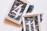 20 table numbers were enclosed in white wooden frames and decorated with black lace