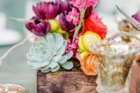 21 a bold summer centerpiece with plum, orange, red and yellow blooms and a pale succulent