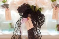 21 blush roses with a black lace bouquet wrap for an elegant and chic look