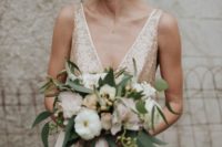 21 champagne-colored wedding dress with wide straps, a deep V cut and gold sequin, a plain skirt