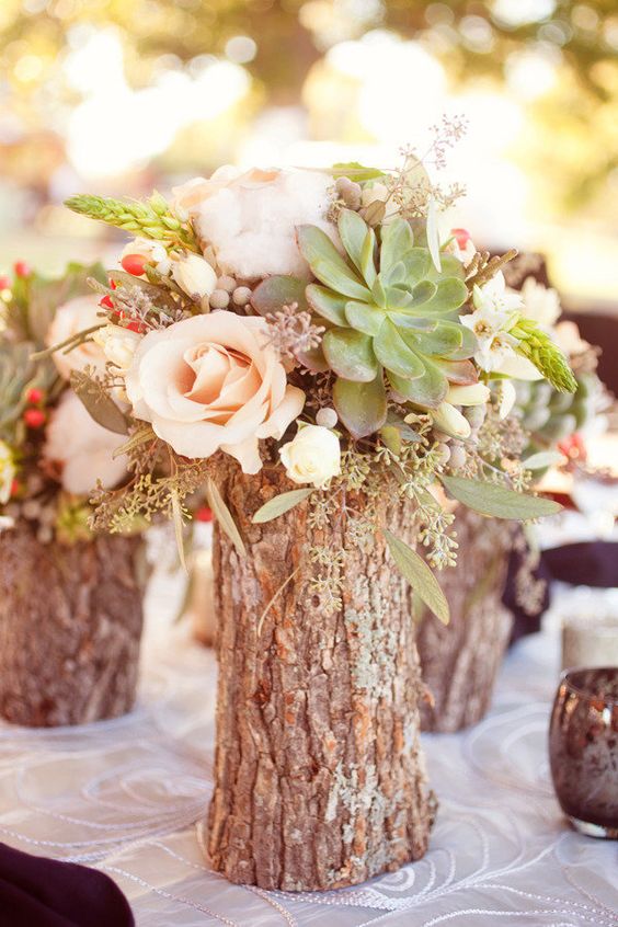 a tree stump with flowers and a succulent will be a nice centerpiece