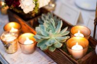 23 a wooden box with blooms in a jar, candles and succulents for a rustic wedding